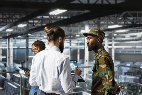 Soldier in server room uses geospatial data to support evacuation Stock Photos