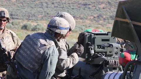 Soldier setting up M777 Howitzer for live fire exercise Stock Footage 111414037