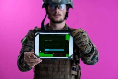 Soldier showing a tablet with a blank green screen Stock Photos