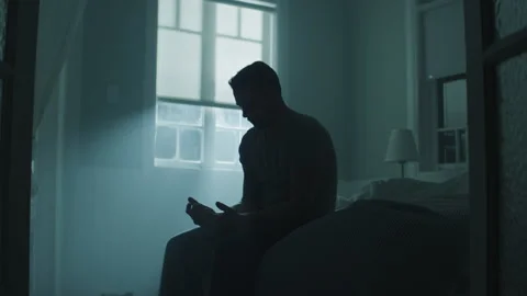 Soldier sitting on the bed and thinking seriously about something Stock Footage 264352001