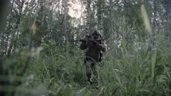 Sniper reload his rifle in forest Stock Photo by ©Nesterenko_Max 89103288