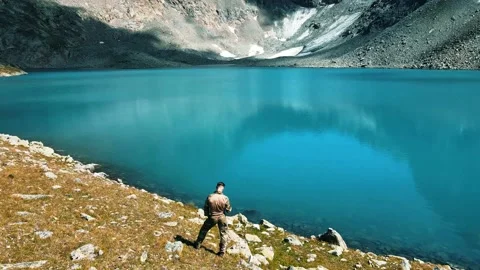A soldier of the special operations squad in a multicam admires a mountain lake Stock Footage 138442682