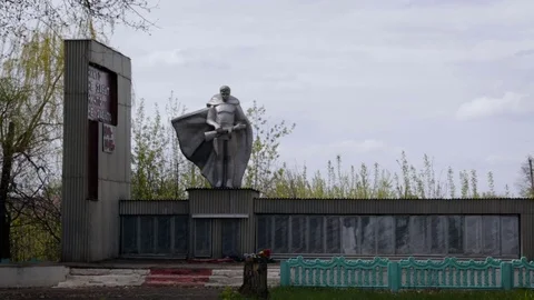 Soldier Statue. Arm in Hands. Stone Memory Wall. Flowers on Floor. Cement Stock Footage 71996486