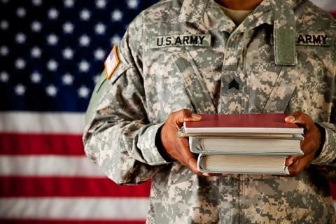 Soldier: student holding stack of school books Stock Photos
