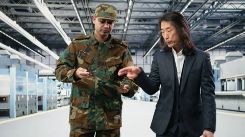 Soldier talks with microchip plant manager, national security concept Stock Footage 333392830