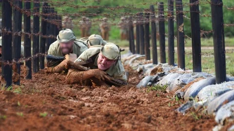 Soldier training crawling through the mud with rifle. Stock Footage 145027624