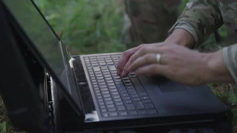 Soldier Typing on the Computer in a Field Stock Footage 208770175