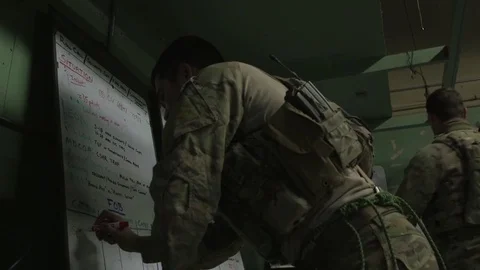 Soldier updating reconnaissance chart Stock-Footage 84390841