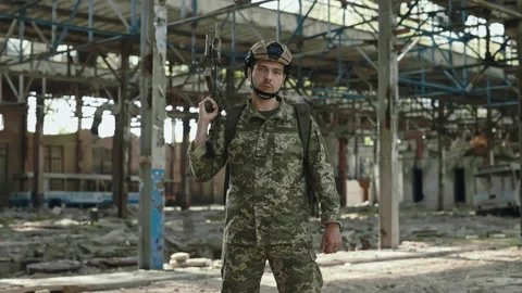 Soldier from US army posing on destroyed plant with gun Stock Footage 201504039