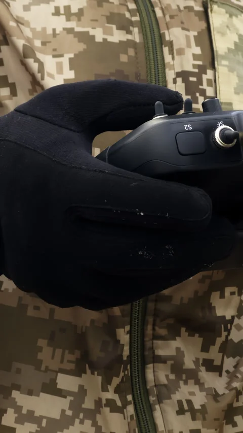 Soldier uses remote control to direct flight of drone toward enemy territory 스톡 동영상 323845810