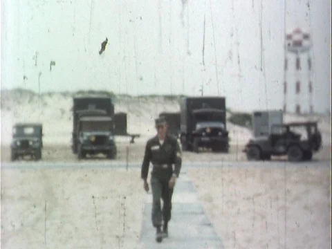 Soldier Walking Down Wooden Path Towards Camera Smiling - Vintage 8mm Stock Footage 78923055