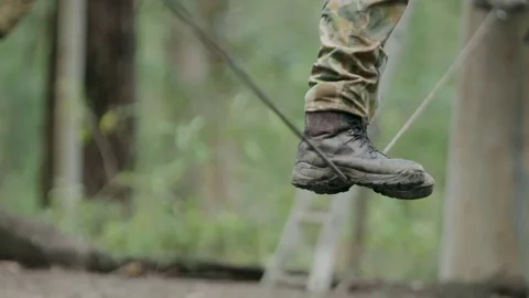 Soldier walking on tight rope Stock Footage 77013307