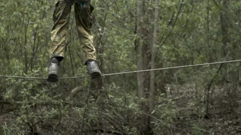 Soldier walking on tight rope Video stock 77014231
