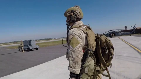Soldier walking towards HH-60 Pave Hawk parked on flightline Stock-Footage 108378917