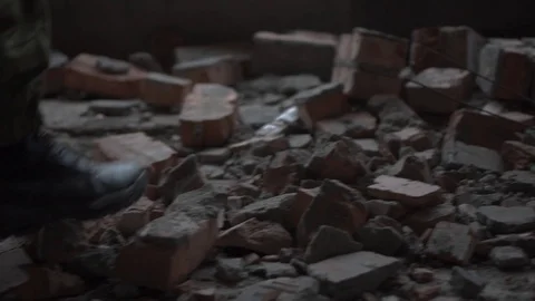 A soldier walks by the bricks Stock Footage 101690901