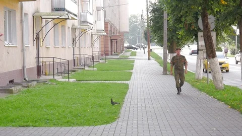 A soldier walks down the street. Stock Footage 104489723
