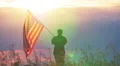 Soldier waves American flag against sunset sky. Slow motion scene HD Footage