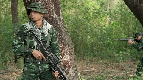 Soldiers aiming their assault rifles in jungle. Stock Footage 92306341