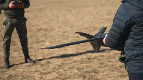 Soldiers are preparing to launch drones in a field, testing engine and Stock Footage 270537980