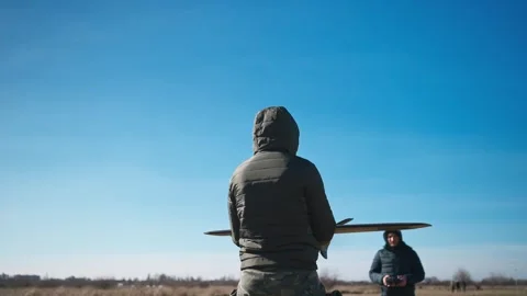 Soldiers are preparing to launch drones in a field, testing engine and Stock Footage 270538197