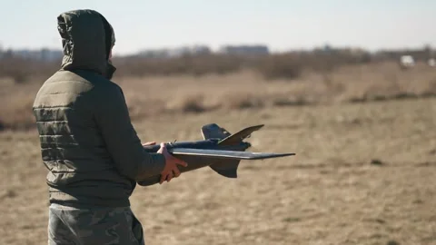 Soldiers are preparing to launch drones in a field, testing engine and Stock Footage 276403597