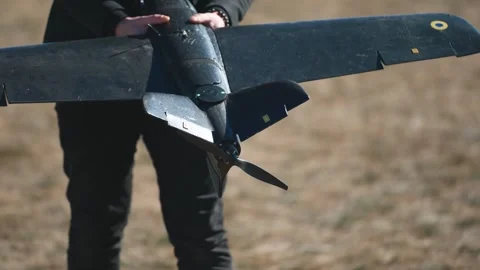 Soldiers are preparing to launch drones in a field, testing engine and Stock Footage 276403711