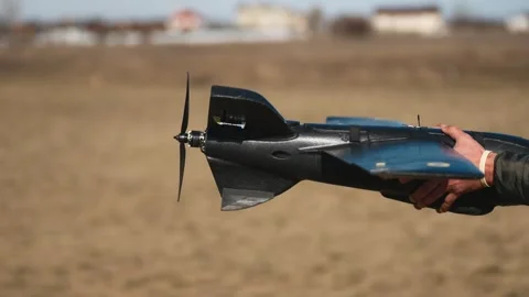 Soldiers are preparing to launch drones in a field, testing engine and Stock Footage 276403804