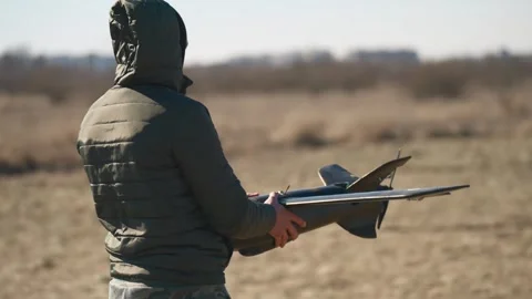 Soldiers are preparing to launch drones in a field, testing engine and Stock Footage 276531691