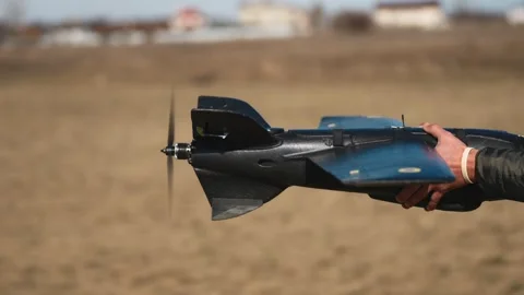 Soldiers are preparing to launch drones in a field, testing engine and Stock Footage 276531925