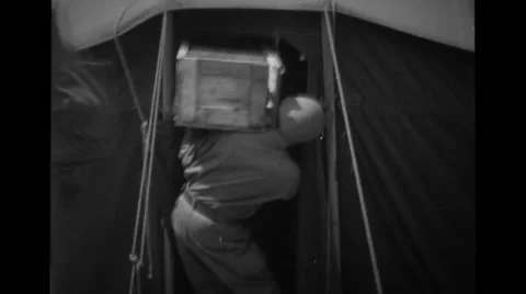 Soldiers carrying boxes inside the tent Stock Footage 36303719