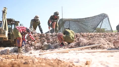 Soldiers constructing stone wall Stock Footage 255645425