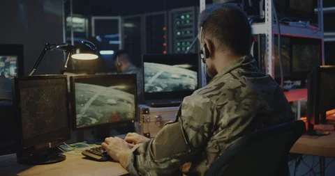 Soldiers controlling rocket launch on computer Stock Footage 116225407