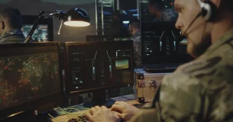 Soldiers controlling rocket launch on computer Stock Photos