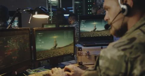 Soldiers controlling rocket launch on computer Stock Photos
