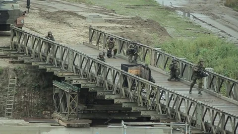 Soldiers crossing bridge Stock Footage 82647397
