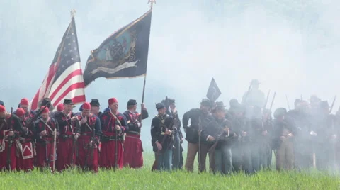 Soldiers fire at will beneath flying flag and colors Stock Footage 39984483