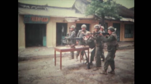 Soldiers firing with M60 machine gun from behind the table Stock Footage