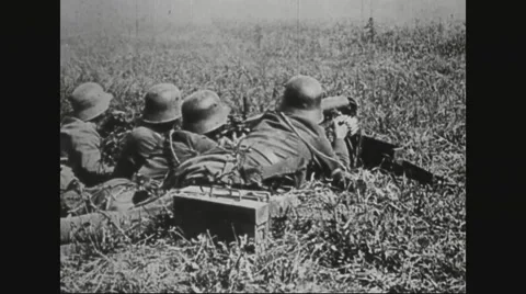 Soldiers firing machine gun while lying in battlefield Stock Footage 43317338