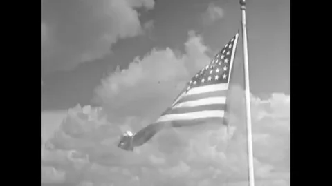 Soldiers in the First Motion Picture Unit salute as they lower the American Stock Footage 79517552