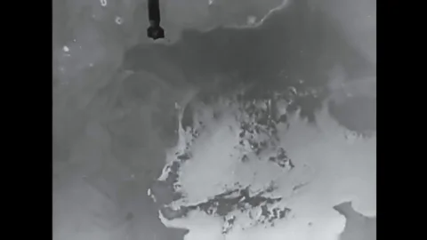 Soldiers install network telephone lines on the battlefield at the bombing of Stock Footage 145415324