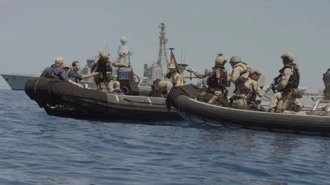 Soldiers interacting on inflatable boat Video stock 97175946