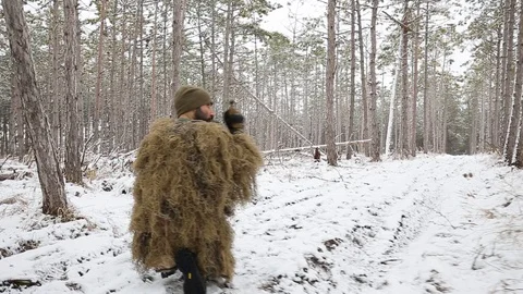 Soldiers lie down on the ground, aiming through the sight of an assault rifle Stock Footage 127977513