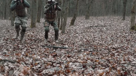 Soldiers lie down on the ground getting ready to shoot in slow motion Stock Footage 131093460