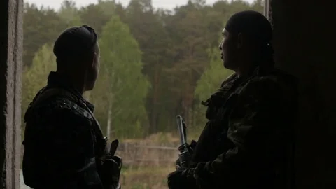 Soldiers looking away at window Stockbeeldmateriaal 77019776