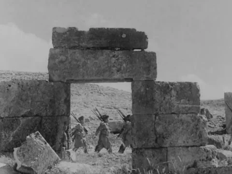 Soldiers march through Middle Eastern arches Video stock 158024787