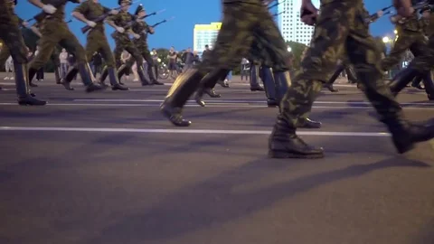 Soldiers marching in a line on a paved road Stock Footage 78422793