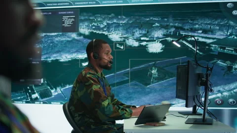 Soldiers in a modern command center analyze live data from cctv radar sources Stock Footage 280149646