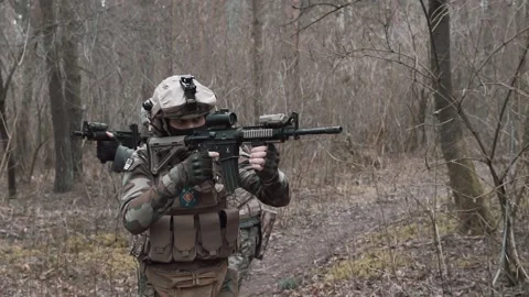 Soldiers move through the forest in slow motion Stock Footage 131093287