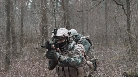 Soldiers move through the forest in slow motion Stock Footage 131093442