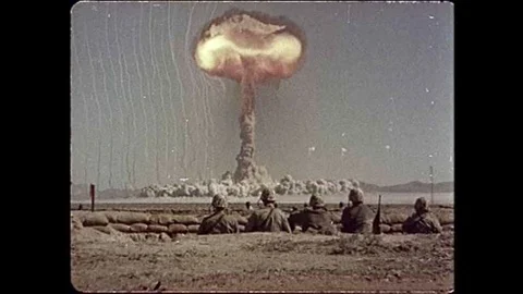 Soldiers observe a spectacular 1951 atomic bomb test at the Nevada Proving Stock Footage